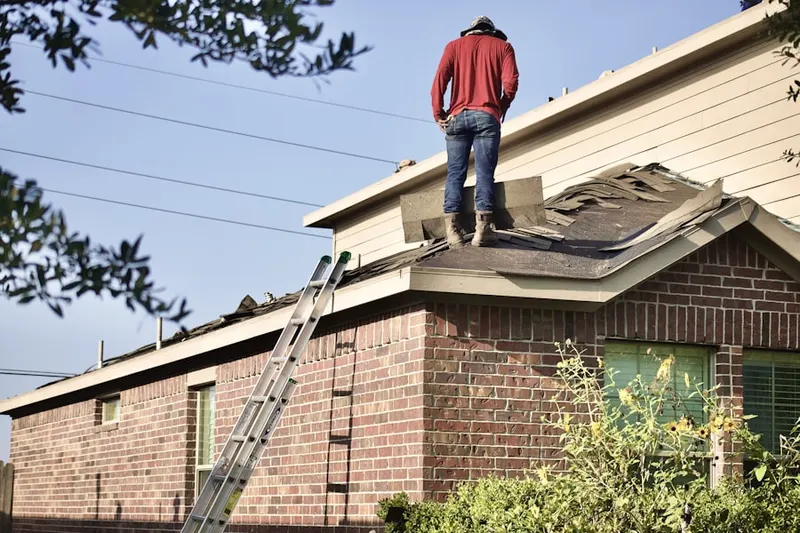 Professional roofer working on a residential roof in Monterey